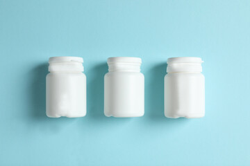 White bottles on color background 