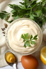 Bowl with mayonnaise and ingredients for cooking on wooden background
