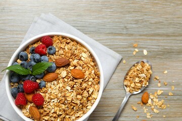 Delicious granola with berries on a wooden background