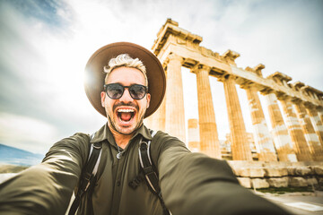 Happy tourist visiting the Acropolis of Athens, Greece - Smiling traveler man taking selfie picture...