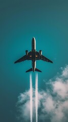 Fototapeta premium Passenger airplane flies high above, leaving contrails against a clear blue sky. The aircraft's silhouette is sharply defined, capturing the essence of modern aviation and travel