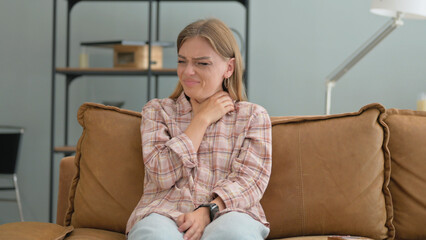 Coughing Young Woman Sitting on Sofa at Home