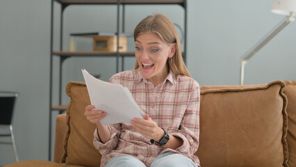 Cheering Young Woman Doing Paperwork at Home