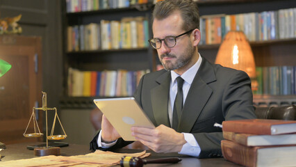 Middle Aged Lawyer Using Tablet in Office