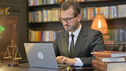 Middle Aged Lawyer Working on Laptop in Office