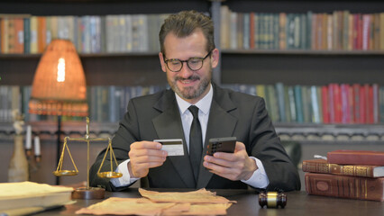 Middle Aged Lawyer Shopping Online with Credit Card and Phone