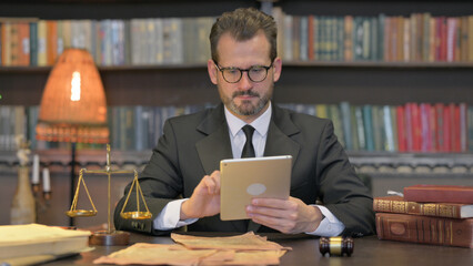 Middle Aged Lawyer Using Tablet in Office