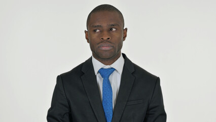 Portrait of Tense African Businessman Looking Around on White Background
