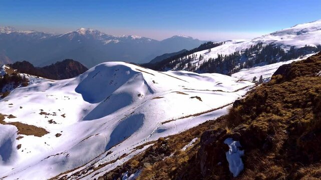 A striking visual of winter view of from summit view of dayra bgyal, showcasing the natural beauty and scenic wonders of the region.