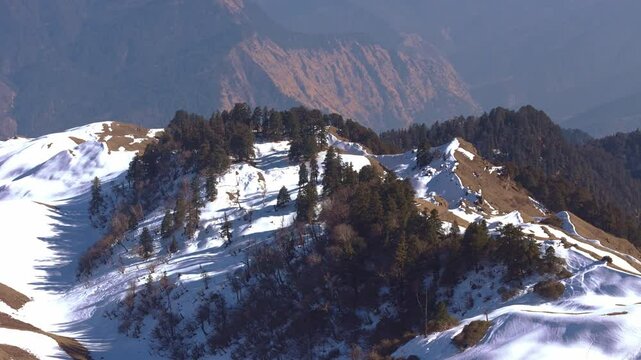 A striking visual of winter view of from summit view of dayra bgyal, showcasing the natural beauty and scenic wonders of the region.