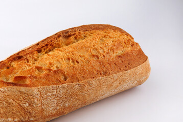 Baguette, part of a loaf on a white background.