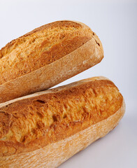 Baguette, two loaves on a white background. Two baguettes on a white background.