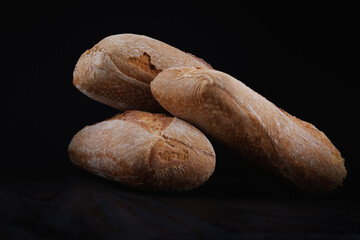 Two beautiful baguettes on a dark background. Art bread. Beautiful baguette.