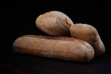 Two beautiful baguettes on a dark background. Art bread. Beautiful French baguette.