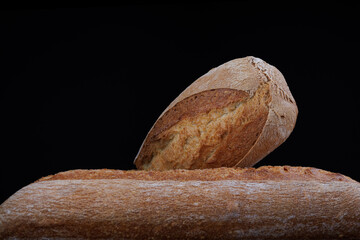 Two beautiful baguettes. Art bread. Beautiful French baguette on a dark background.