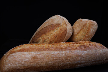 Two beautiful baguettes. Art bread. Beautiful French baguette on a dark background.