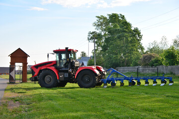 Powerful Red Tractor in a Field