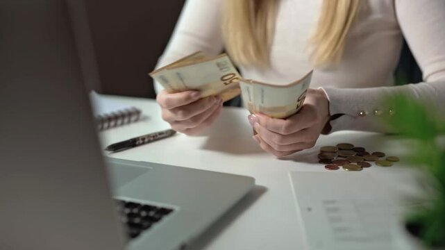 Close-up of a woman counting money. Paying for education, a foundation for the future. Budgeting is an important part of modern life. Loans and collateral do not give a sense of freedom