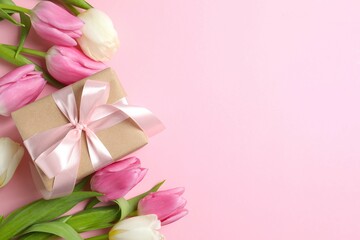 Beautiful fresh tulips with gift box on color background