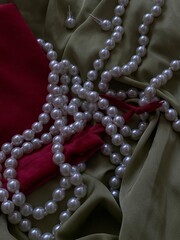 pearl necklace on red satin