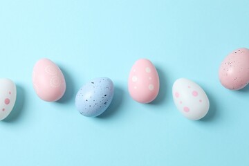 Happy Easter. Colorful eggs on a pastel blue background, space for text or advertising
