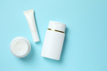 Natural cosmetic products on a blue background, top view