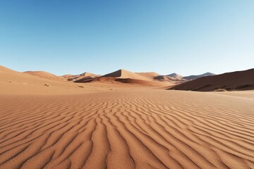 Rippling sand dunes stretch across a vast desert under a clear blue sky during midday