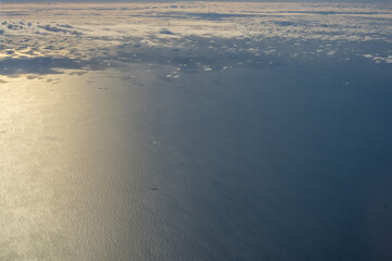 London, United Kingdom, England, a view of the ocean from an aeroplane window with clouds in the sky