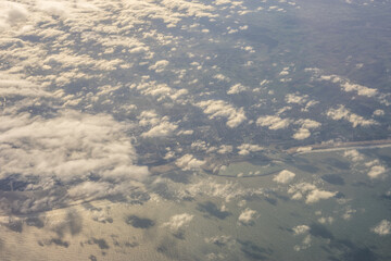 London, United Kingdom, England, a view of the ocean from an aeroplane window with clouds in the sky