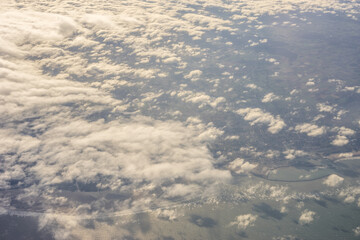 London, United Kingdom, England, a view of the ocean from an aeroplane window with clouds in the sky
