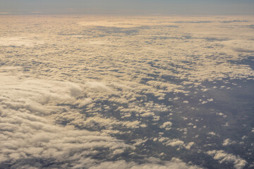 Aerial view of morning clouds at golden hour sunrise through the clouds