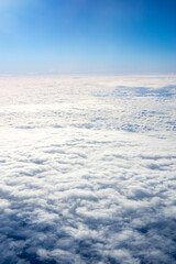 View of clouds from airplane window, clouds in a blue sky