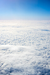 View of clouds from airplane window, clouds in a blue sky