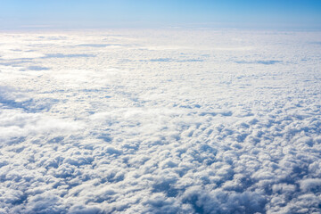 View of clouds from airplane window, clouds in a blue sky