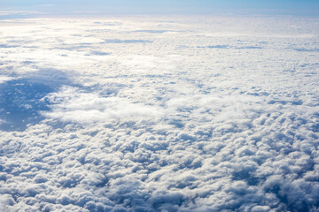 View of clouds from airplane window, clouds in a blue sky