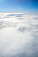 View of clouds from airplane window, clouds in a blue sky