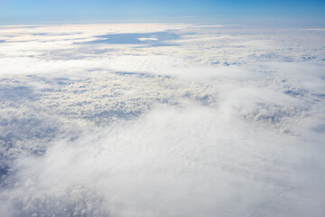 View of clouds from airplane window, clouds in a blue sky