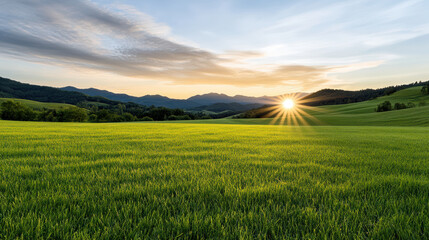 Obraz premium scenic countryside sunrise with rolling green hills and mountains