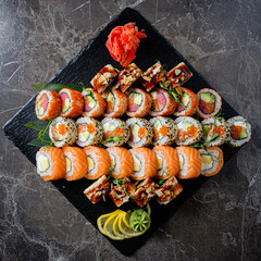 Vibrant Sushi Assortment Elegantly Displayed on a Sleek Black Stone Platter, Featuring Colorful...