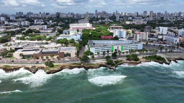 Santo Domingo, Dominican Republic, westbound flight from "Banco Agr&iacute;cola" and Ministry of Foreign Affairs Convention Center along Av. George Washington (Malec&oacute;n) 4k aerial video footage