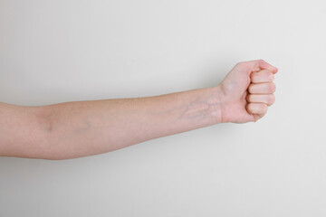 Woman with visible hand veins on white background, closeup