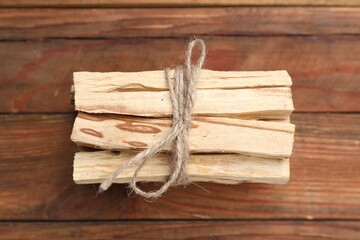 Bunch of palo santo sticks on wooden table, top view