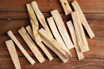 Palo santo sticks on wooden table, flat lay