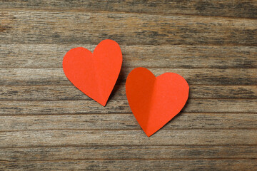 Valentine's Day. Paper hearts on wooden background, top view