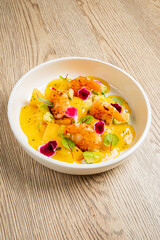Vibrant Culinary Delight Featuring Succulent Shrimp With Citrus-Infused Sauce, Garnished With Fresh Herbs and Edible Flowers on a Rustic Wooden Table