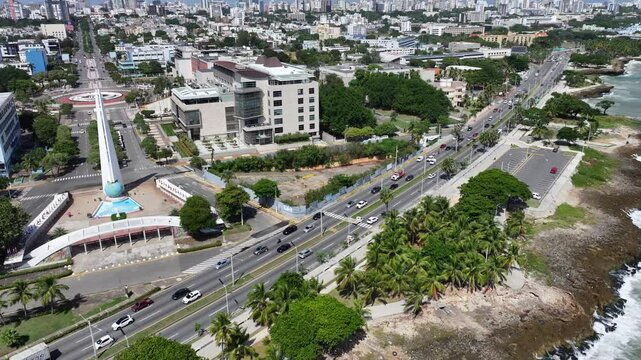 Santo Domingo, Dominican Republic, hovering near Monument to the Heroes of Constance, Maimon and Estero Hondo located in park Centro de Los Heroes, with cars on road, 4k aerial video footage
