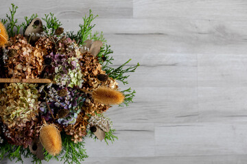 Dried Floral Arrangement Beautifully Displayed on a Rustic Wooden Surface for Aesthetic Appeal