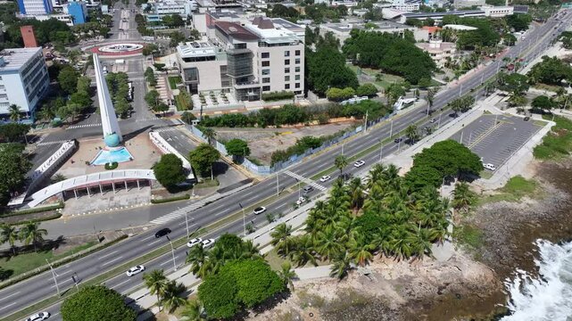 Santo Domingo, Dominican Republic, flying from Monument to the Heroes of Constance along Av. George Washington with government buildings in background  , 4k aerial video footage