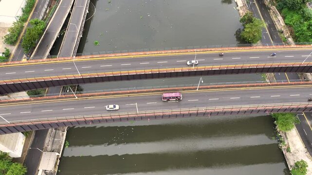 Santo Domingo, Dominican Republic, panning from top view above Puente Mat&iacute;as Ram&oacute;n Mella Bridge to forward view along R&iacute;o Ozama Riverto Juan Pablo Duarte bridge , 4k aerial video footage