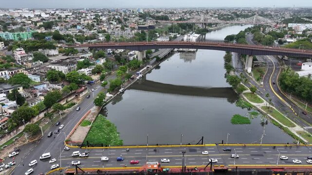 Santo Domingo, Dominican Republic, flying along R&iacute;o Ozama River via Puente Flotante a Floating Bridge,   "Mat&iacute;as Ram&oacute;n Mella" Bridge to Puente Juan Pablo Duarte  , 4k aerial video footage